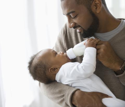 Father bottle-feeding baby
