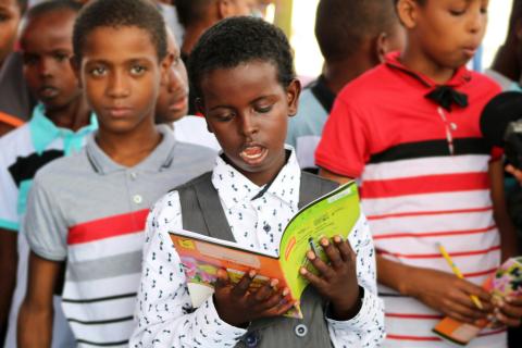 Boy reading from a book