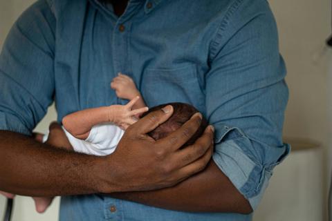 Father holding newborn baby