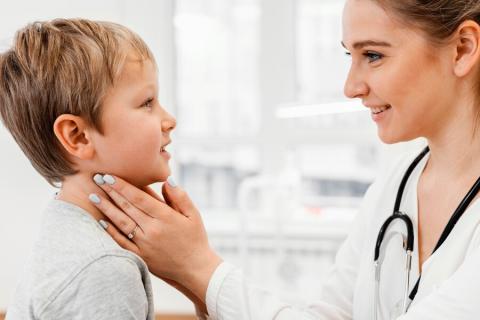 Doctor checking child's lymph nodes