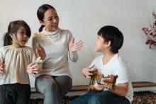 A mother is singing with her two children