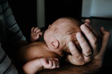 newborn girl in fathers hands