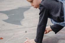 girl drawing with chalk on the street