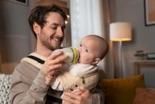 Father feeding baby bottle