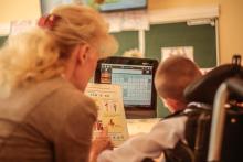 Adult and child using adapted chatboard